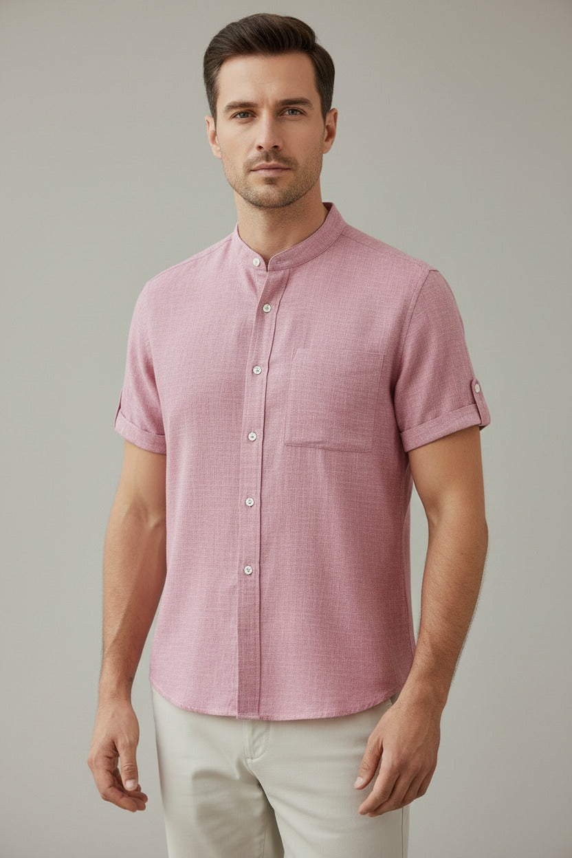 Pink short-sleeve shirt on a hanger against a white background