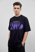 Black t-shirt with purple graphic design on a mannequin against a gray background