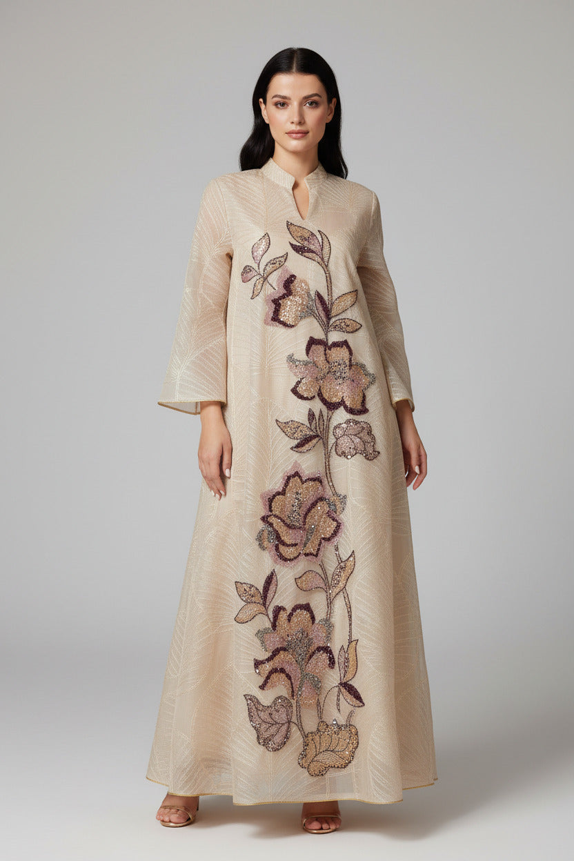 Woman in a floral embroidered dress standing in a sunlit archway with warm-toned walls.