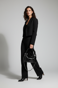 Close-up of a black crinkled faux-croc leather handbag with a ruched shoulder strap and a silver chain strap, featuring the text 'Chrs'2ab' on the front against a light gray background.