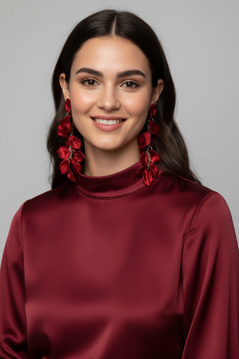Red floral earrings on a beige background