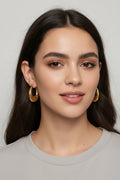Gold-plated stainless steel crescent hoop earrings with a textured crocodile skin pattern, shown with dimension markings of 19mm width and 25mm height, and text indicating 18k gold plating and 9.49g weight.