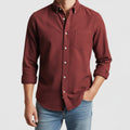 Maroon button-up shirt worn by a person on a light gray background