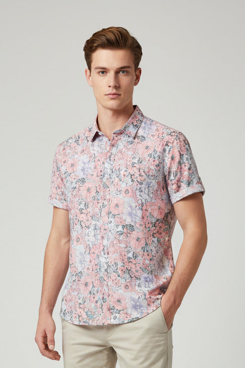 Floral patterned shirt on a hanger with a white background