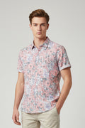 Floral patterned shirt on a hanger with a white background