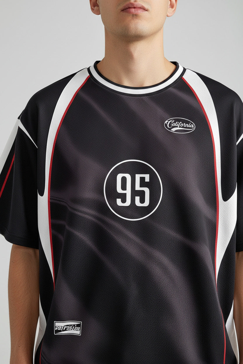 A black short-sleeve athletic jersey with white side panels, red piping details, and a white circular '95' printed on the chest.