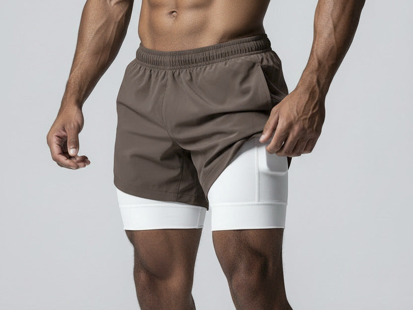 Person holding a smartphone with a white athletic shorts featuring an Apple logo.