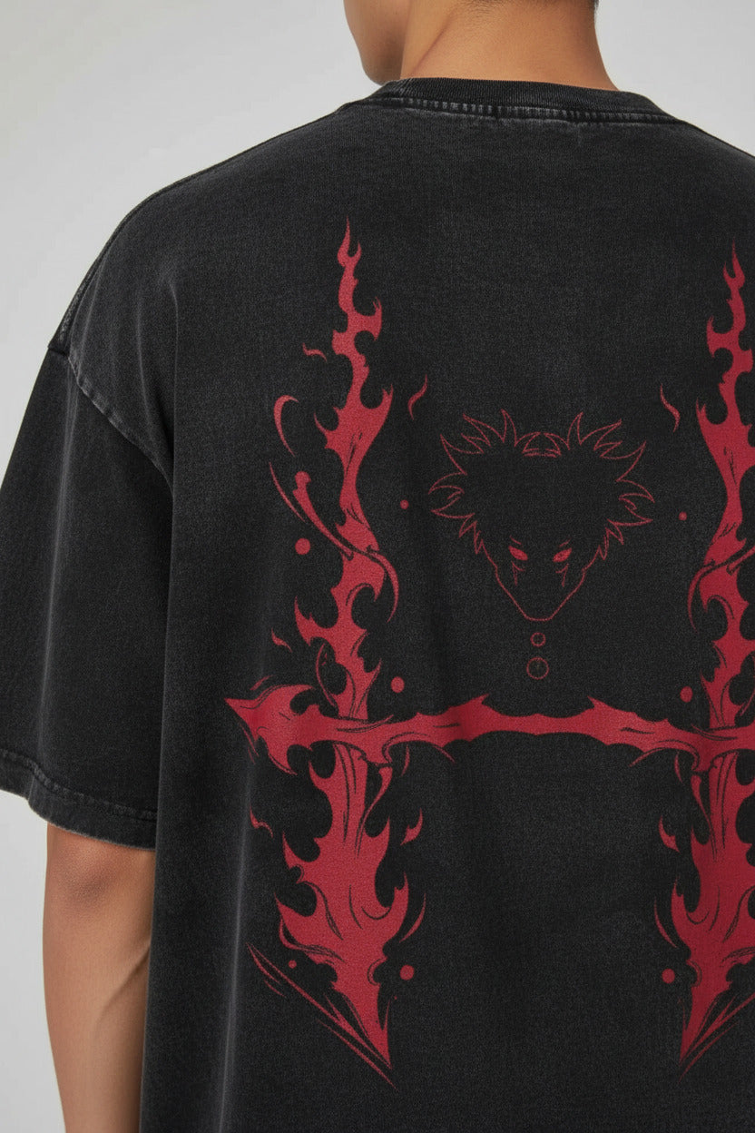 A black acid-wash graphic t-shirt featuring an anime character print on the back with a glowing orange eye and gold text, alongside a smaller front-view inset showing a matching chest graphic.