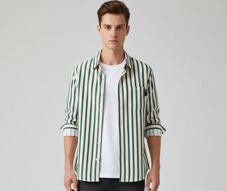 Green and white striped shirt on a hanger against a gray background