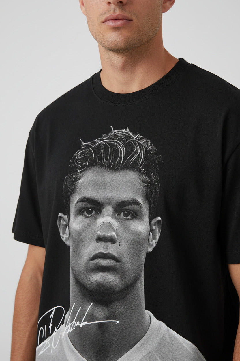 Black t-shirt with a graphic of a person on the front and a logo on the back, displayed on a white background.