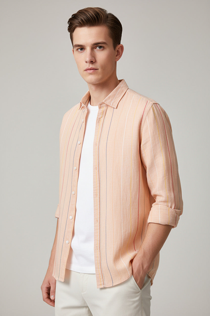 Light pink striped shirt over a white t-shirt on a wooden hanger against a gray textured wall.