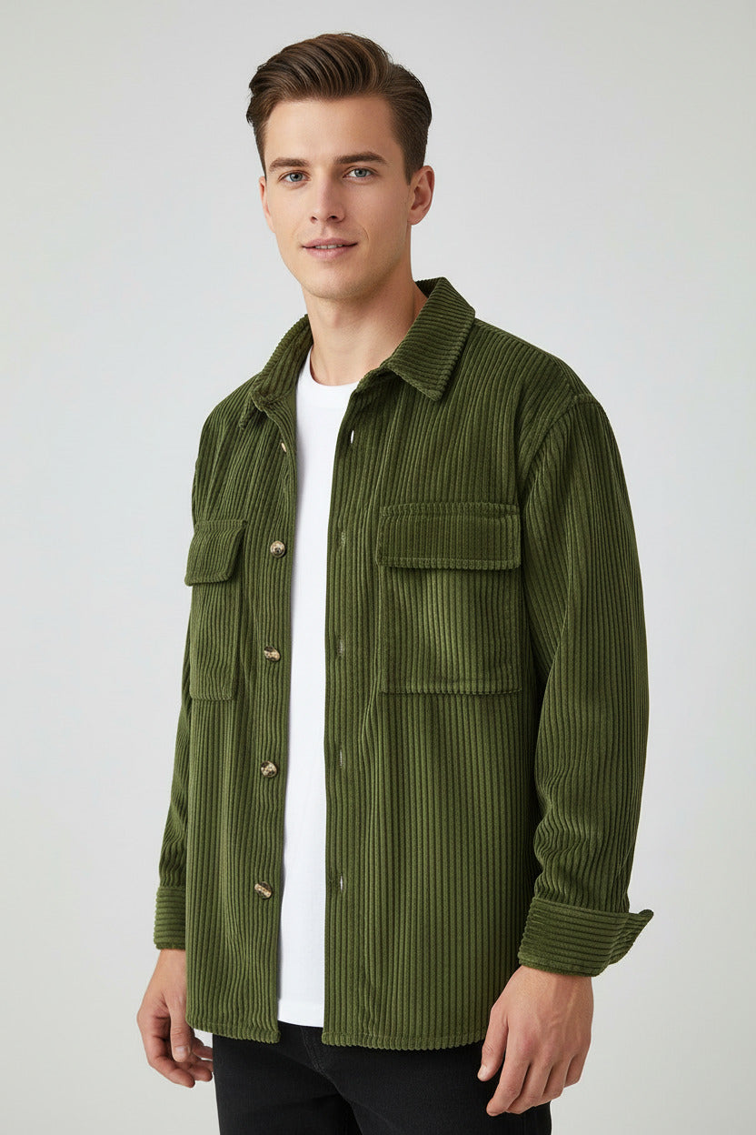 Green corduroy jacket on a hanger against a gray background