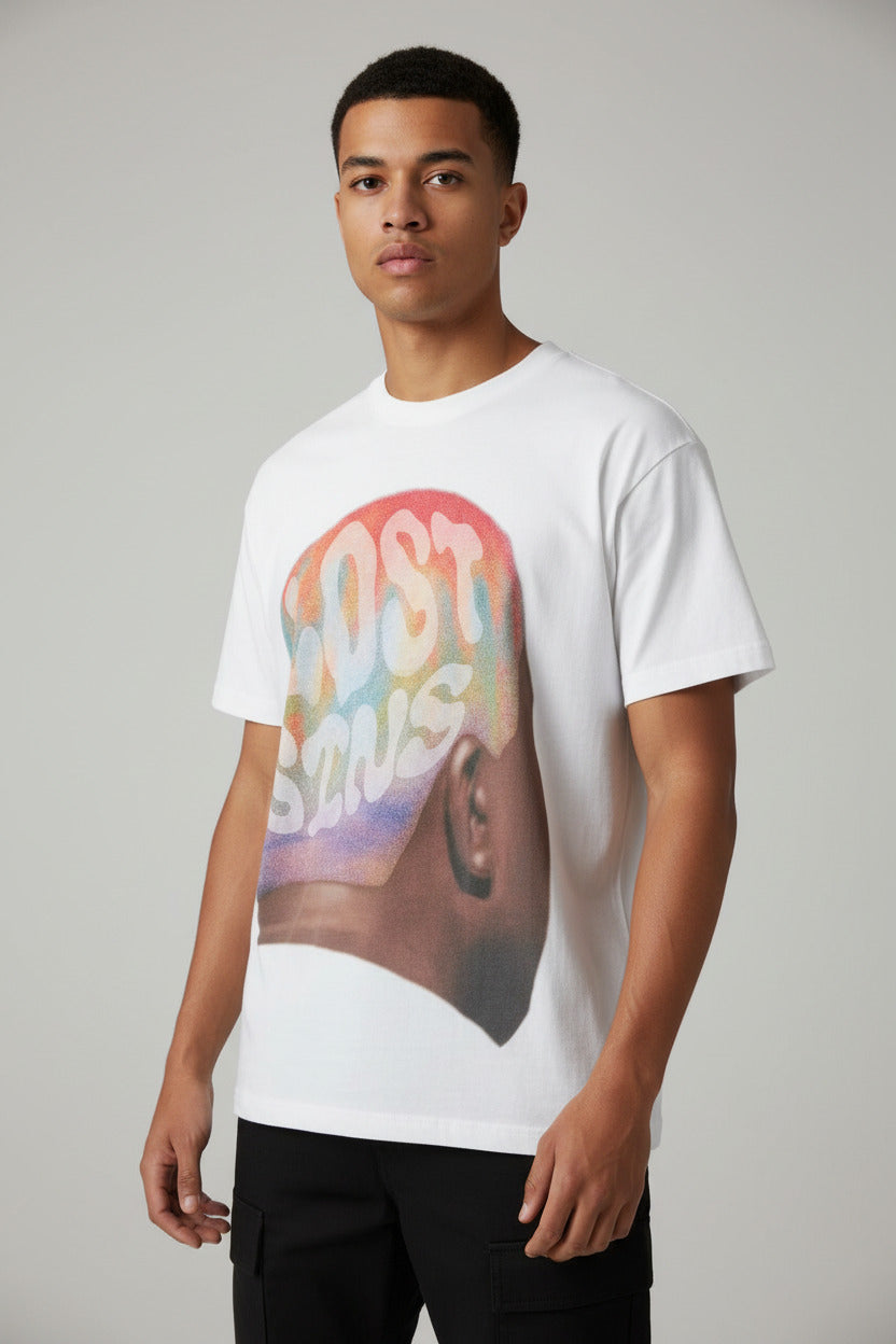 White t-shirt with colorful graphic design on a wooden floor
